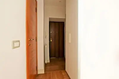 a hallway with a door leading to a room at Maisonette Coppedé in Rome