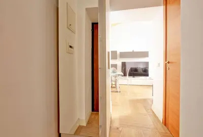 a hallway leading to a room with a mirror at Maisonette Coppedé in Rome