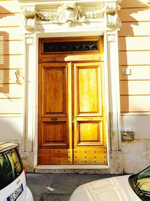 a wooden door on the side of a house at Maisonette Coppedé in Rome