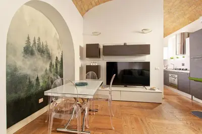 a kitchen with a table and chairs in a room at Maisonette Coppedé in Rome
