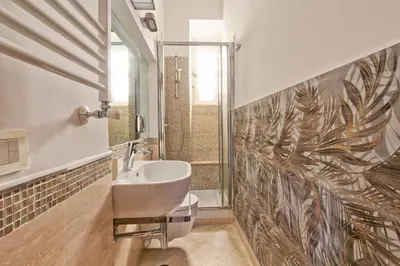 a bathroom with a sink and a shower at Maisonette Coppedé in Rome