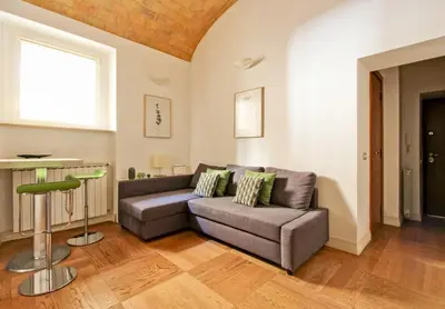 a living room with a couch and a table at Maisonette Coppedé in Rome