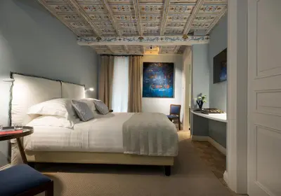 a bedroom with a bed and a coffered ceiling at Palazzo Caruso in Rome
