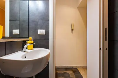 a bathroom with a white sink in a room at A casa di Ale e Lalla in Rome