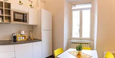 a kitchen with a table and chairs and a window at A casa di Ale e Lalla in Rome