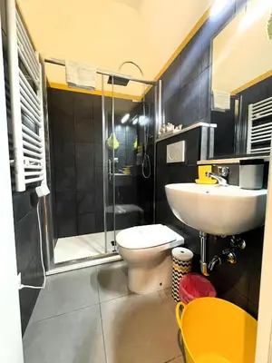 a bathroom with a toilet and a sink and a shower at A casa di Ale e Lalla in Rome