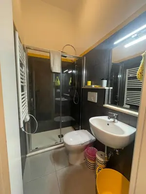 a bathroom with a shower and a toilet and a sink at A casa di Ale e Lalla in Rome