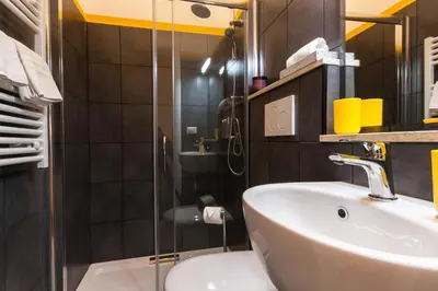 a bathroom with a sink and a shower at A casa di Ale e Lalla in Rome