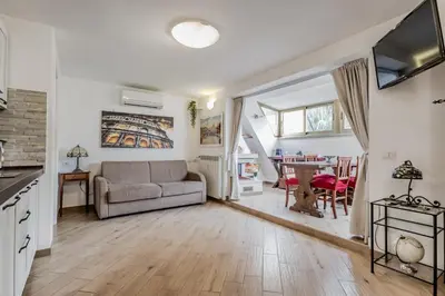 a living room with a couch and a table at Il Nido di Lulu in Rome