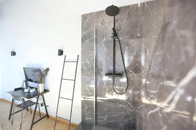 a bathroom with a shower with a glass door at KISS ME ROME Luxury Rooms in Rome