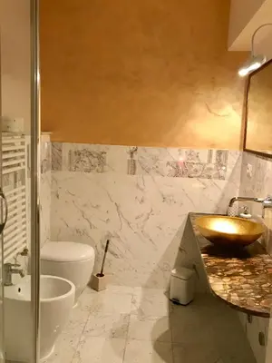 a bathroom with a sink and a toilet and a tub at Biancalunagiulia in Rome