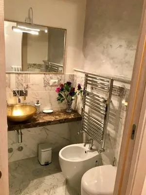 a bathroom with a sink and a toilet and a mirror at Biancalunagiulia in Rome