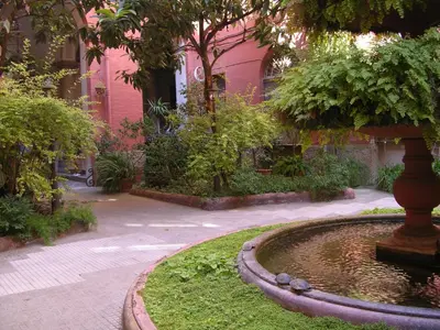 a fountain in front of a pink building at Biancalunagiulia in Rome