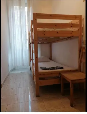 a bedroom with two bunk beds in a room at Varese Guest House in Rome