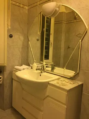 a bathroom with a sink and a mirror at Varese Guest House in Rome