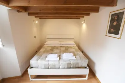a bedroom with a bed in a white room at Lo Chalet in Rome