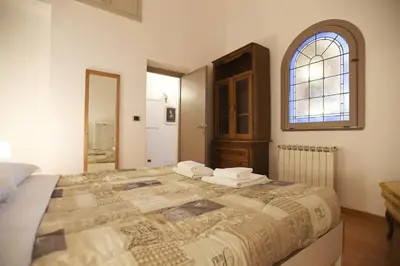 a bedroom with a large bed and a window at Lo Chalet in Rome