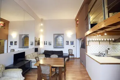 a kitchen and a living room with a table and chairs at Lo Chalet in Rome