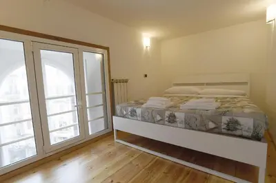 a bedroom with a bed and a large window at Lo Chalet in Rome