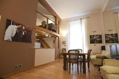 a living room with a table and chairs and a couch at Lo Chalet in Rome