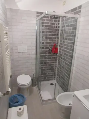 a bathroom with a shower with a toilet and a sink at PIANETA ROMA 39 in Rome