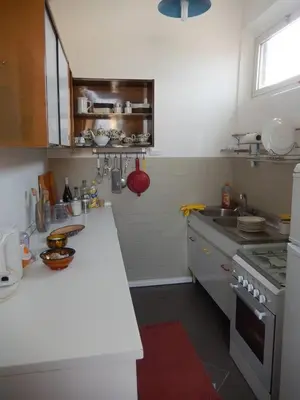 a kitchen with a stove and a counter top at Porto Fluviale House in Rome