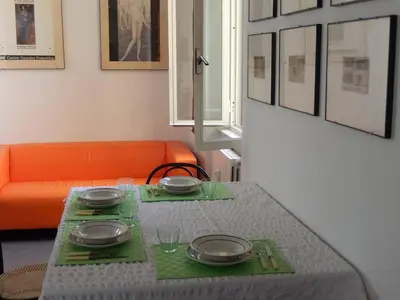 a table with plates and utensils on top of it at Porto Fluviale House in Rome