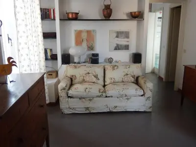 a living room with a couch in a room at Porto Fluviale House in Rome