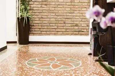 a room with a tile floor with a flower on it at Maison Colosseo (Via dei Querceti 24) in Rome