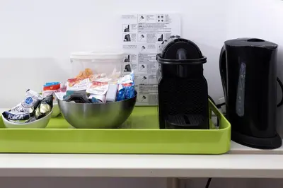 a green tray with two bowls and a blender at Maison Colosseo (Via dei Querceti 24) in Rome