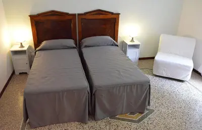 a bedroom with two beds and two night stands at Maison Colosseo (Via dei Querceti 24) in Rome