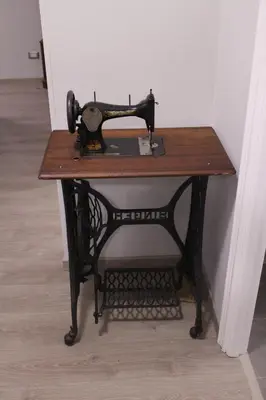 an old sewing machine sitting on top of a table at Green view apartment in Rome