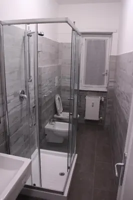 a bathroom with a shower with a toilet and a sink at Green view apartment in Rome