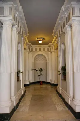 a hallway with white columns and a potted plant at Deko Rome in Rome