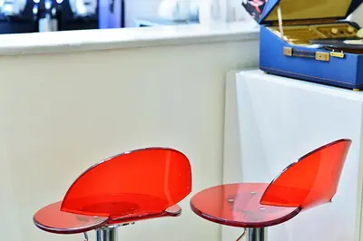 two red chairs sitting next to a counter at Deko Rome in Rome