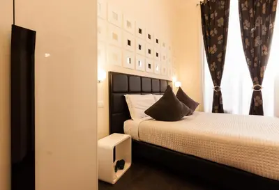 a bedroom with a bed with a black headboard at Deko Rome in Rome