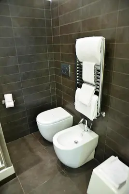 a bathroom with a white toilet and a sink at Deko Rome in Rome
