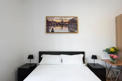 a bedroom with a bed and a picture on the wall at St. Paul Palace Relais in Rome