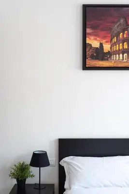 a bedroom with a bed and a picture on the wall at St. Paul Palace Relais in Rome