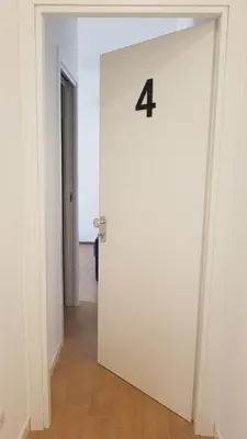 a white door with the number four on it at St. Paul Palace Relais in Rome