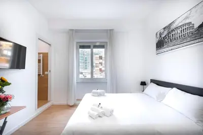 a bedroom with a large white bed with towels on it at St. Paul Palace Relais in Rome