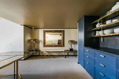 a dining room with blue cabinets and a mirror at Luxurious loft facing the Pantheon in Rome