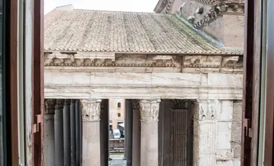 a view of the facade of a building with columns at Luxurious loft facing the Pantheon in Rome