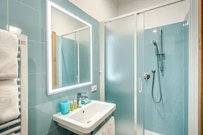 a bathroom with a sink and a shower at La Residenza Suites in Rome