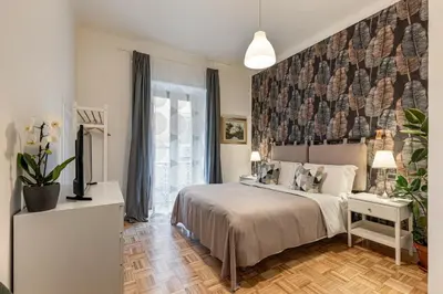 a bedroom with a bed and a large window at Urbana Apartment Colosseum in Rome
