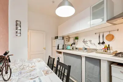 a kitchen with a table and chairs and a counter top at Urbana Apartment Colosseum in Rome