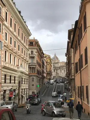 a busy city street with cars and buildings at Urbana Apartment Colosseum in Rome