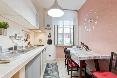 a kitchen with a counter and a table with chairs at Urbana Apartment Colosseum in Rome