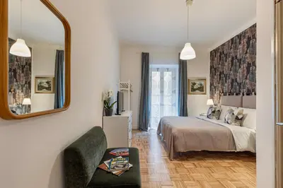 a bedroom with a bed and a mirror at Urbana Apartment Colosseum in Rome