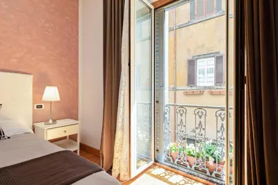 a bedroom with a bed and a large window at Urbana Apartment Colosseum in Rome
